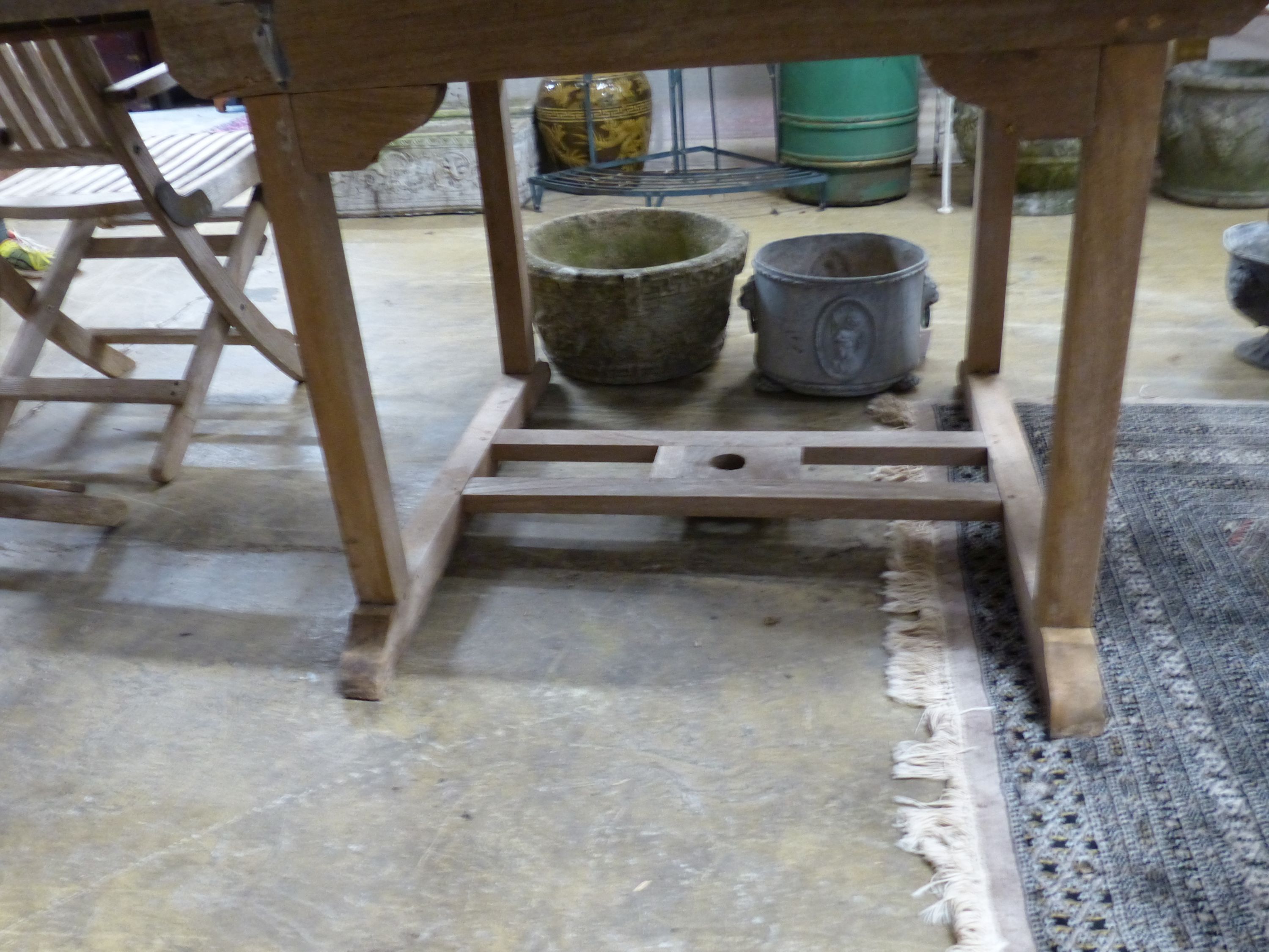 A 'Westminster' extending teak garden table, length 171cm and a set of six folding chairs